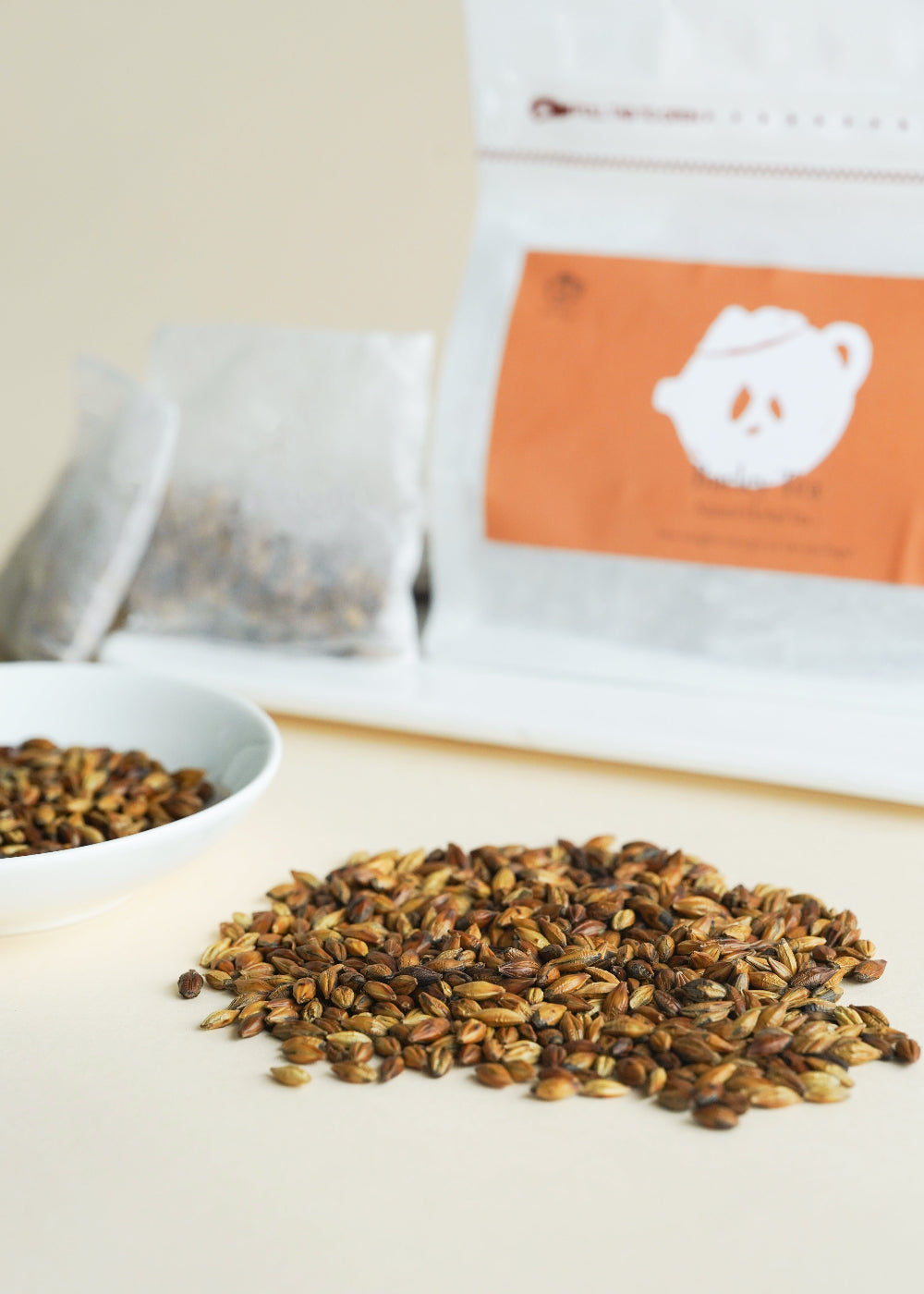 Spices on a white surface with a branded package in the background