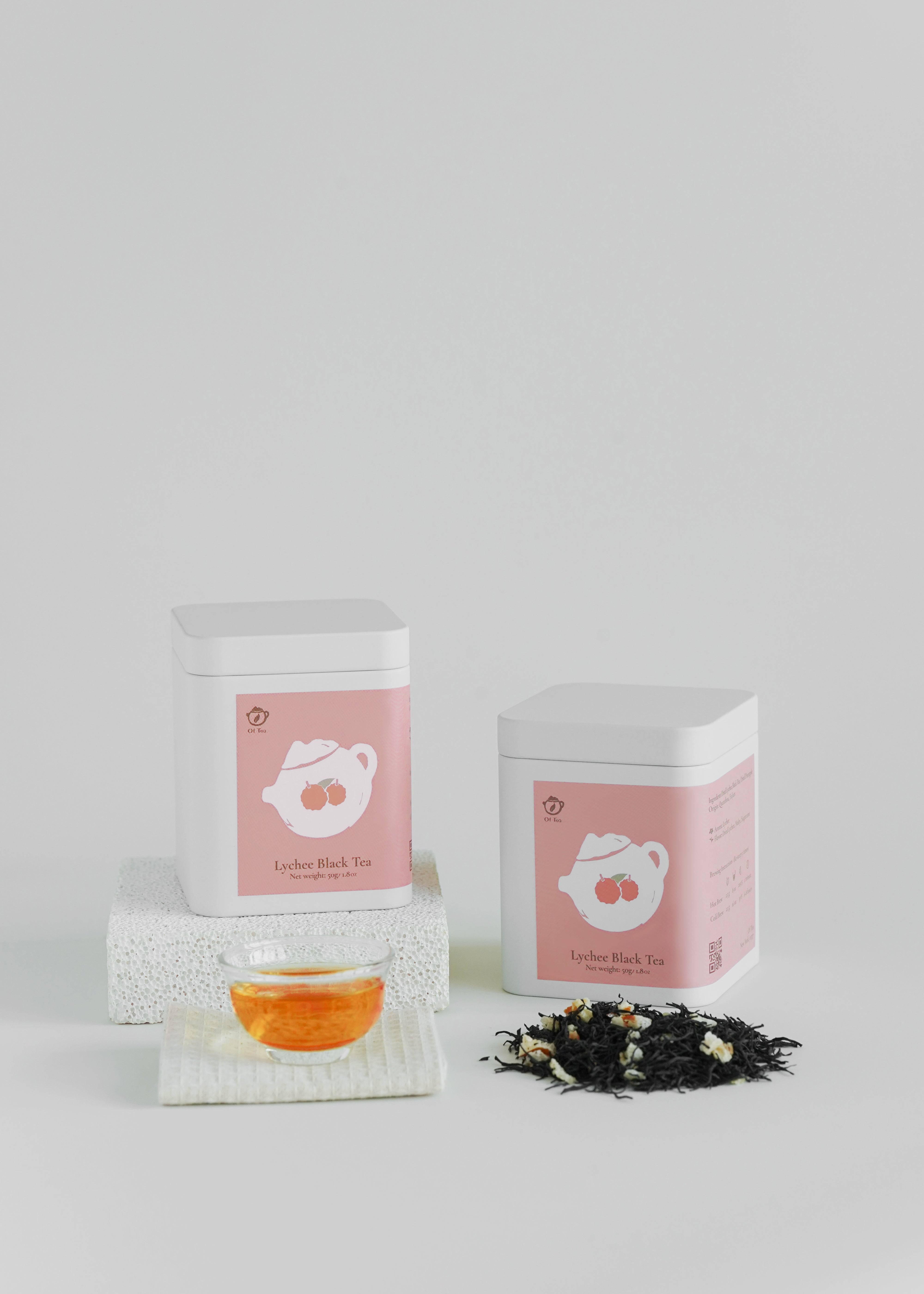 Tea packaging with a pink label featuring a tea cup illustration on a white background. Lychee black tea