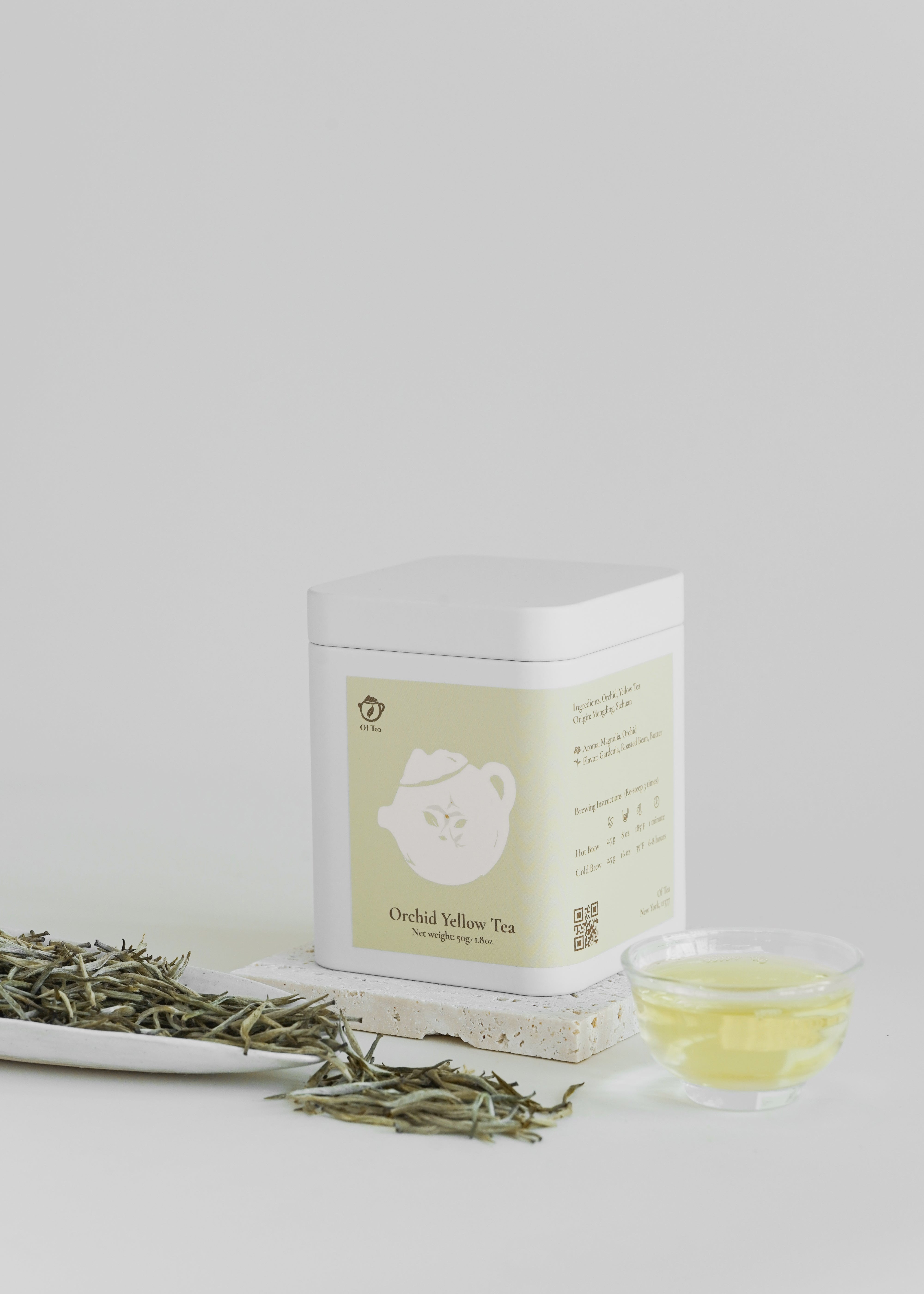 Tea packaging with tea leaves and a cup of tea on a light background. Orchid yellow tea