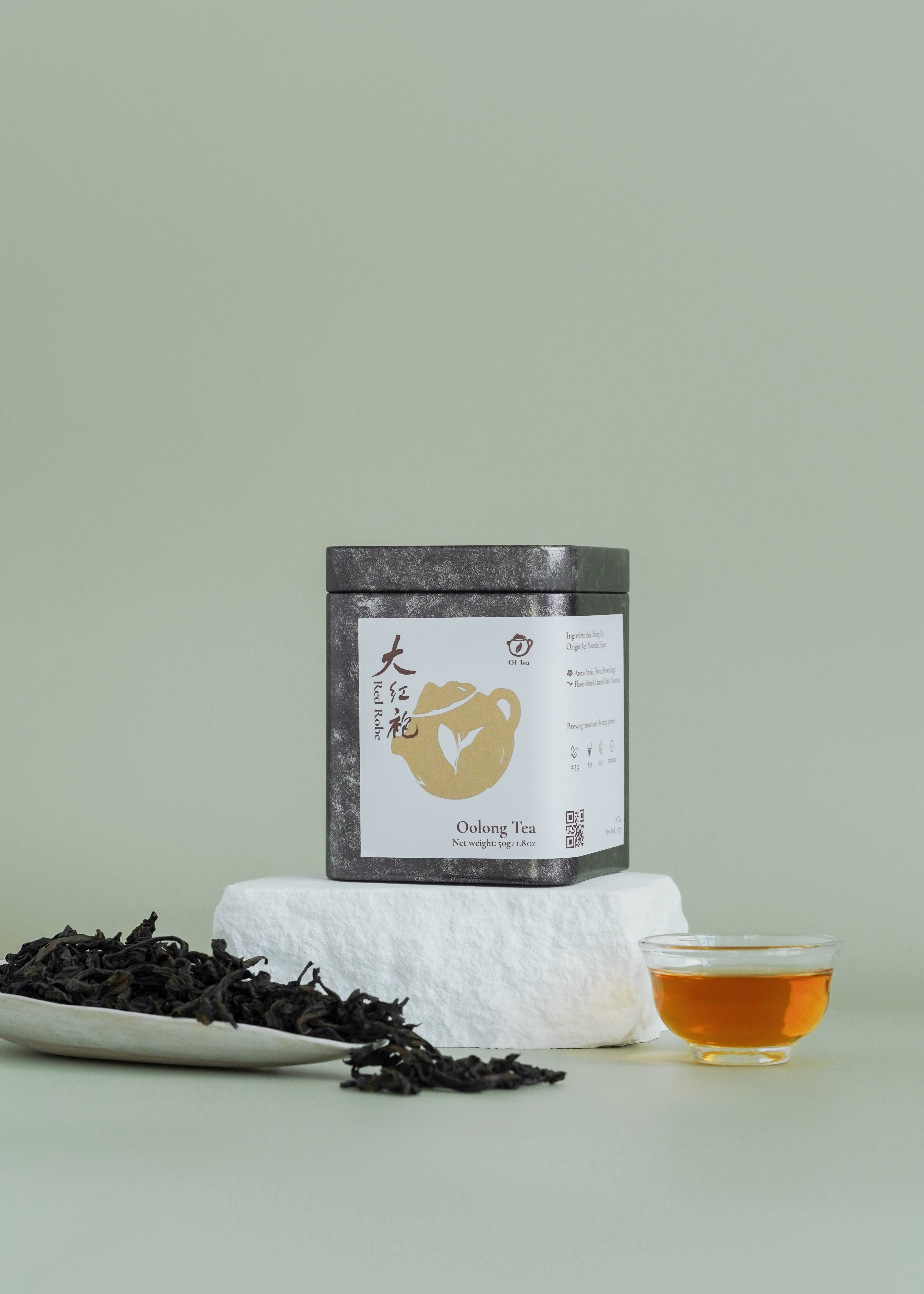 Tea packaging with tea leaves and a cup of tea on a light green background. Big red robe, da hong pao