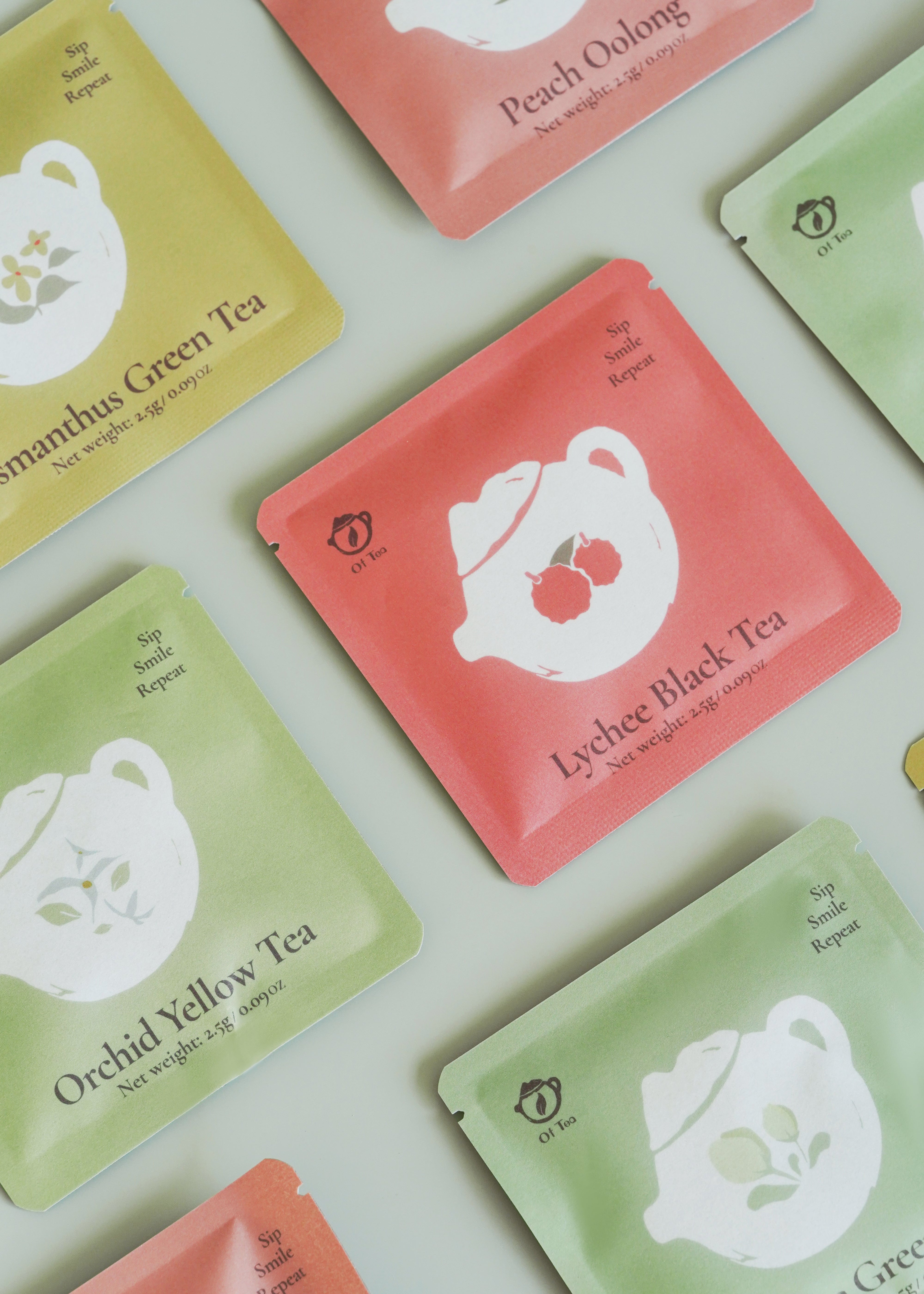 Tea bags with various flavors on a light green background