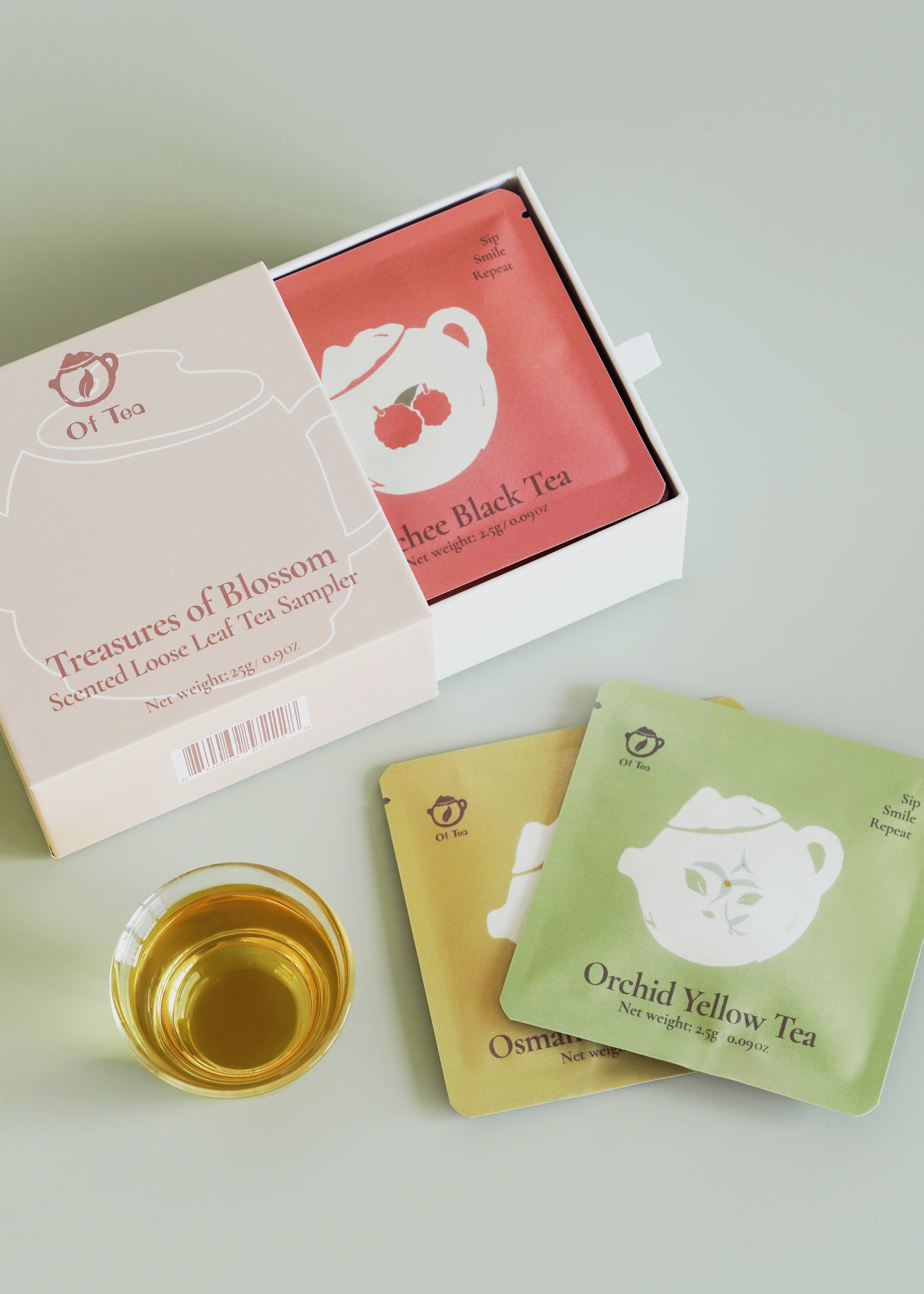 Tea bags and a glass of tea on a light surface