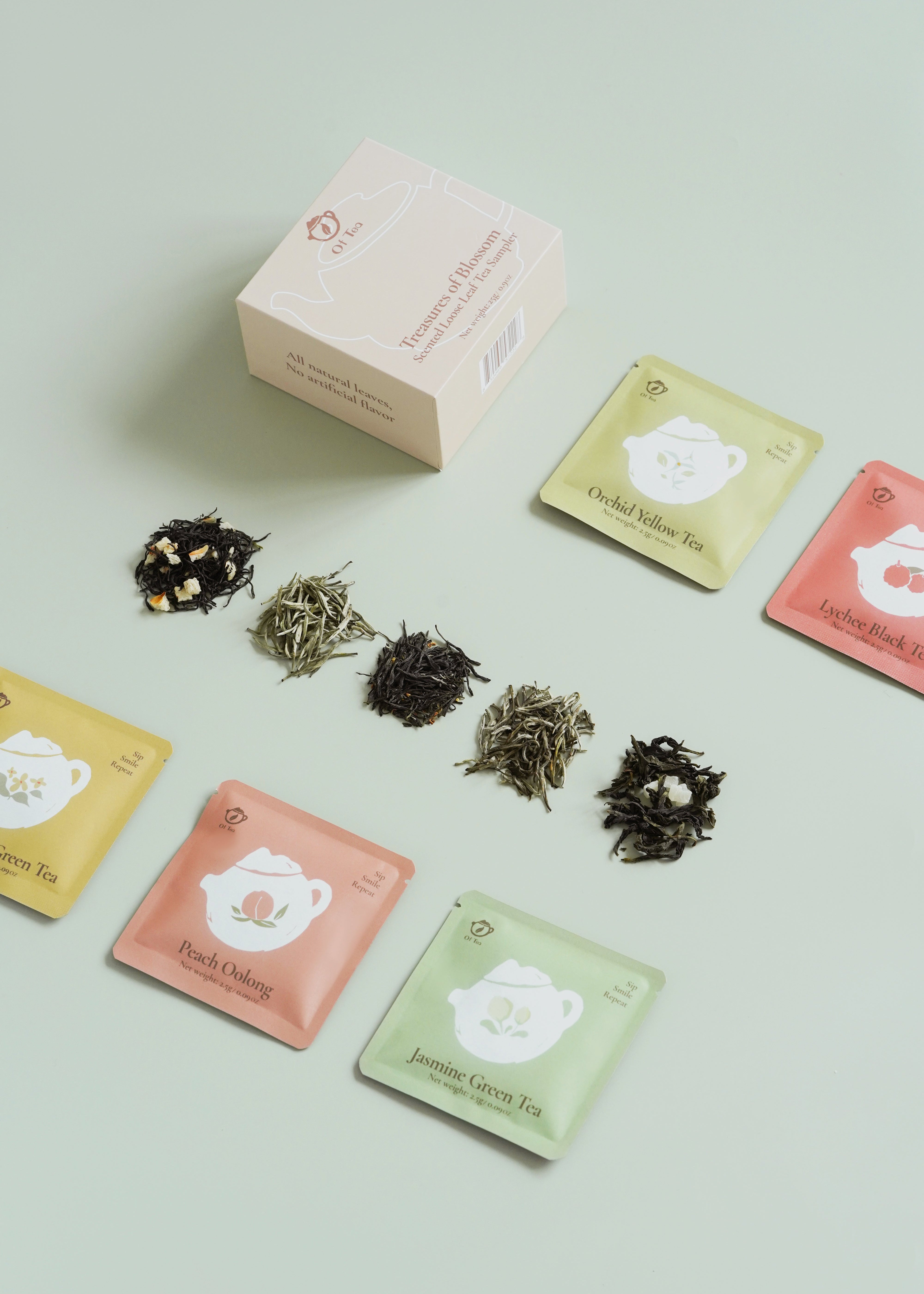 Tea packaging with loose tea leaves on a light green background