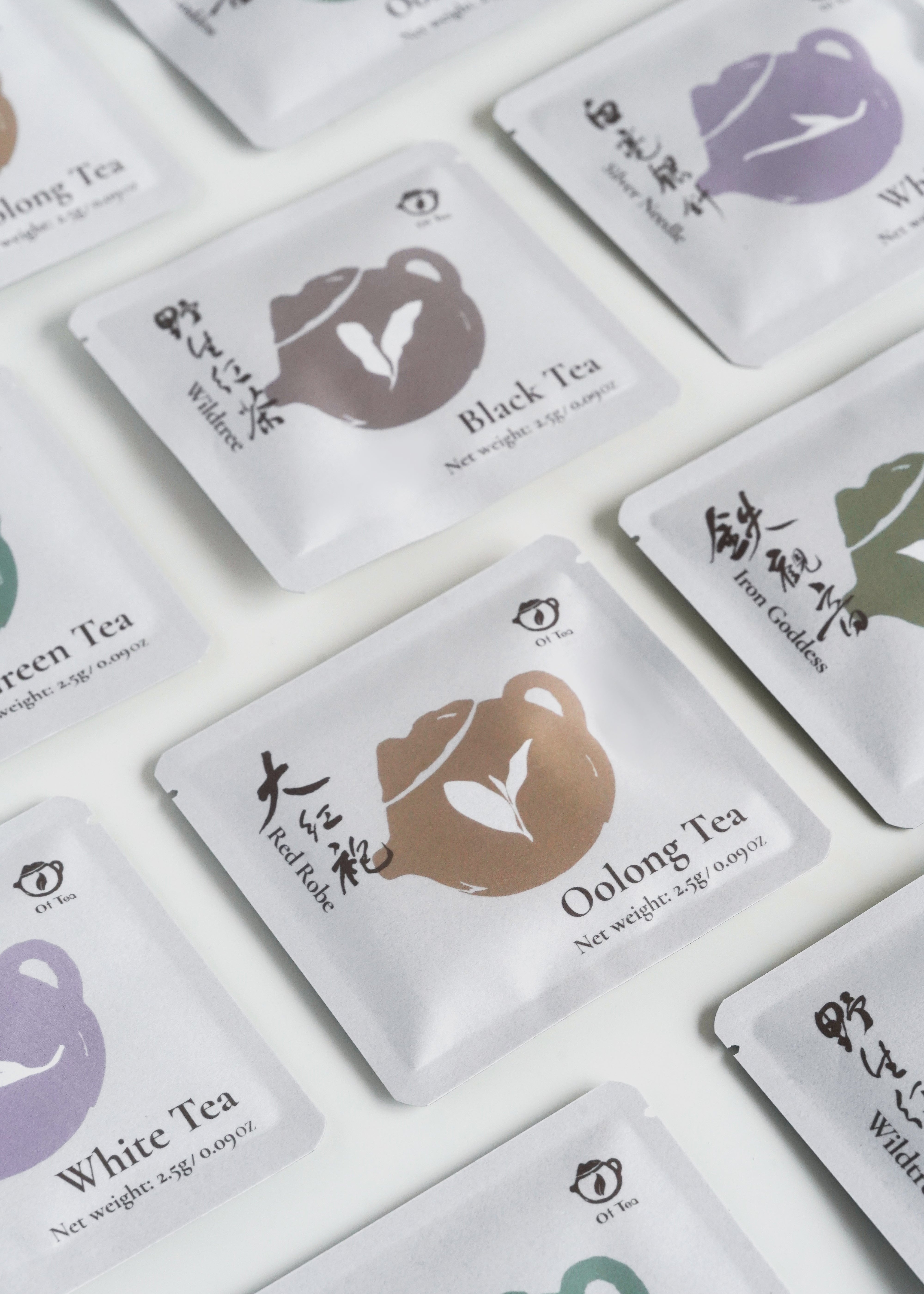Tea bags with different types of tea on white background