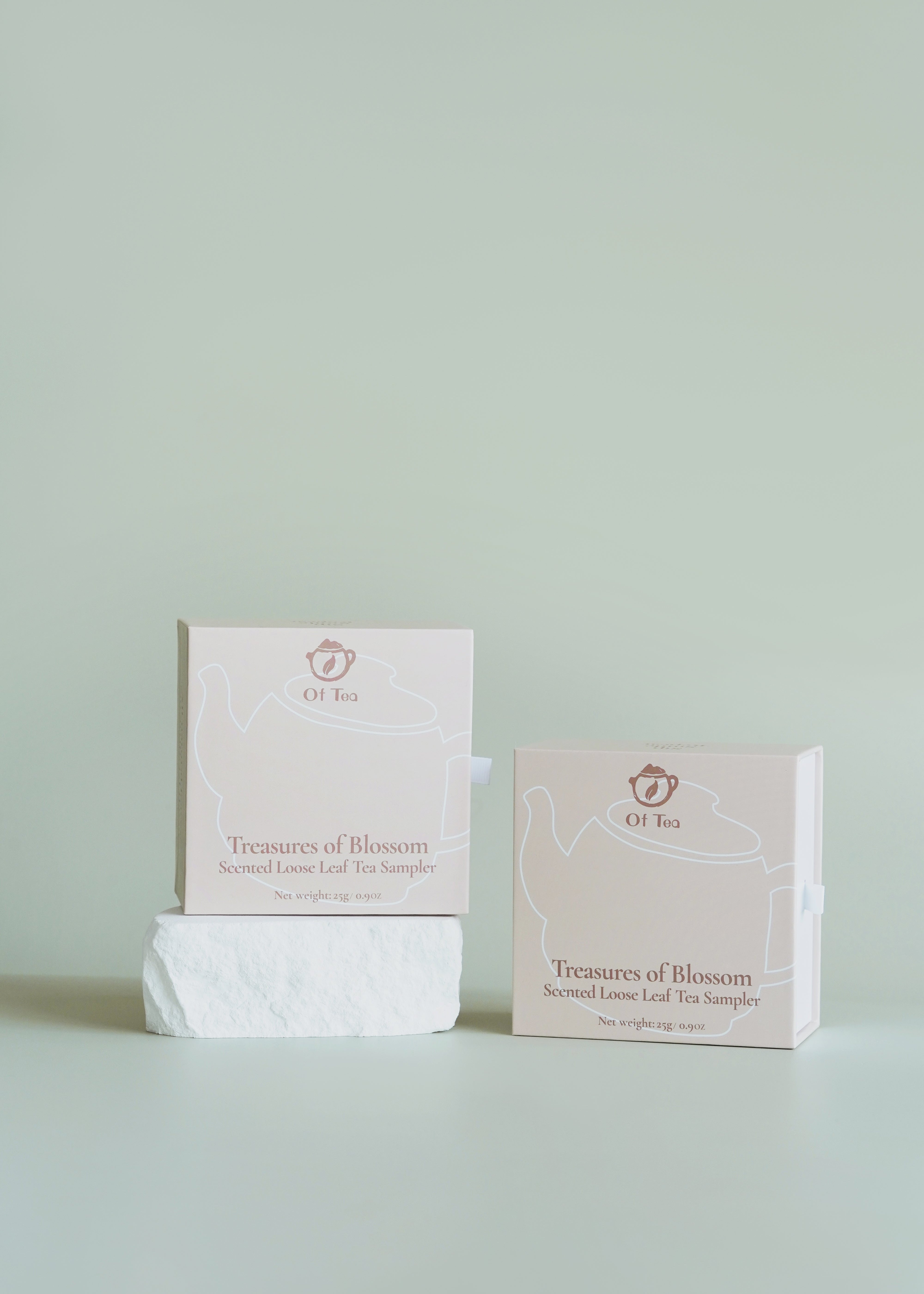 Two boxes of 'Treasures of Blossom' tea on a light green background