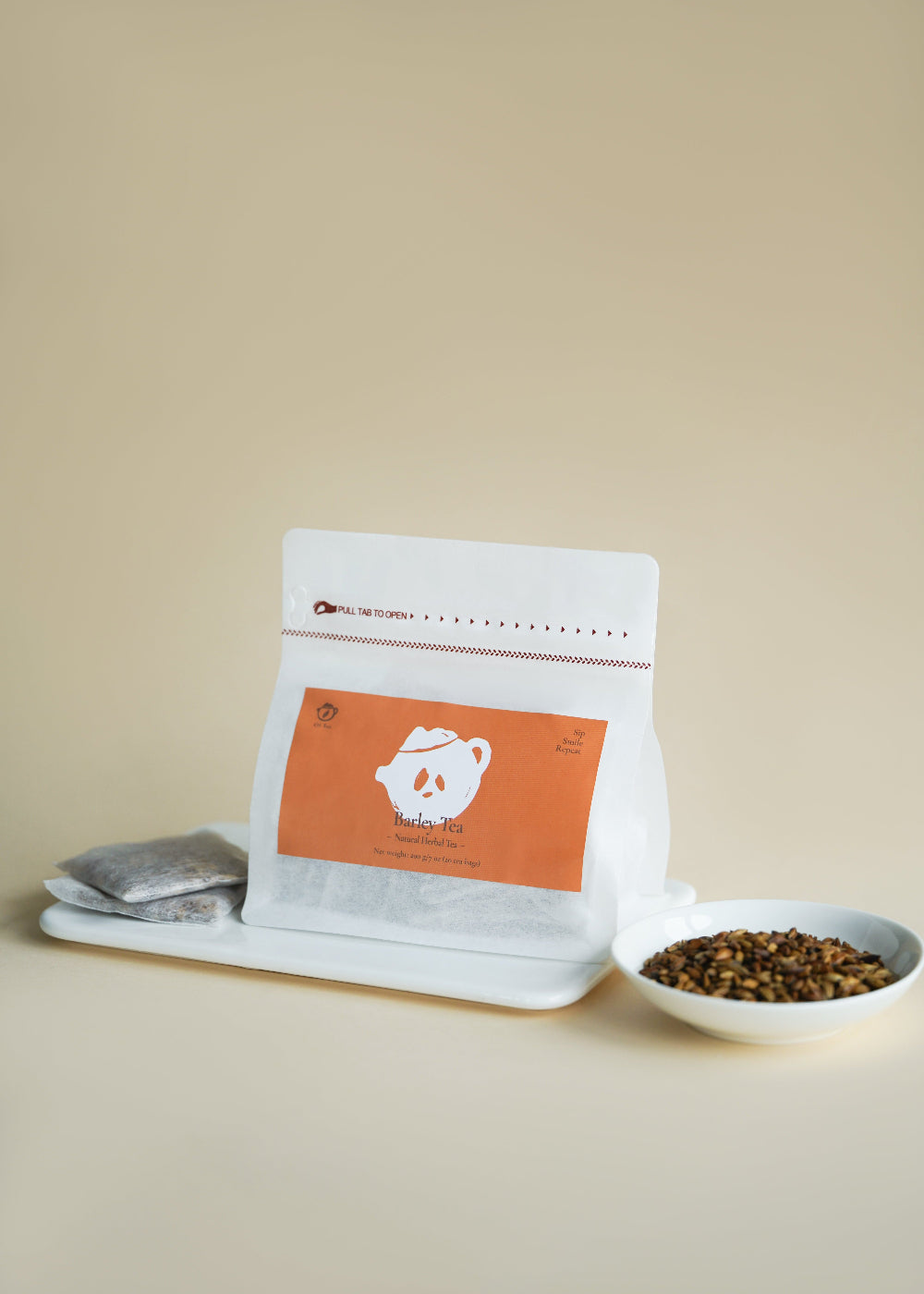 White coffee bag with orange label on a beige background